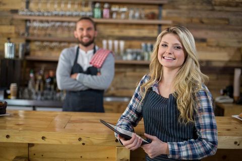 Smiling Waitress Holding Digital Tablet in Cozy Cafe - Download Free Stock Images Pikwizard.com