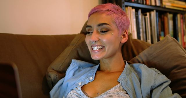 Woman With Pink Hair and Piercings Smiling While Using Laptop - Download Free Stock Images Pikwizard.com