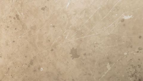 Beige Marble Countertop Showing White Veins, Linear Scratches, Stains and Weathered Patina