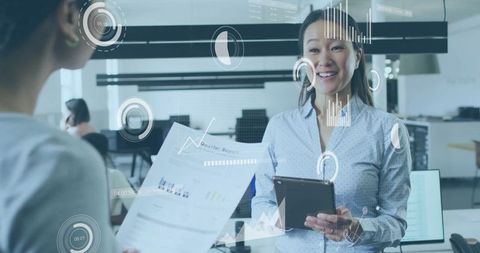Businesswoman Using Tablet Analyzing Data in Modern Office