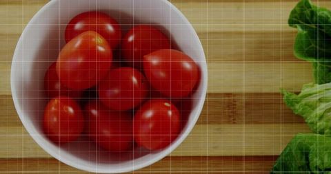 Fresh Grape Tomatoes in White Bowl on Bamboo Cutting Board