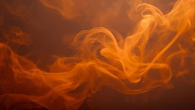 Ethereal Orange Smoke Swirls on Dark Background