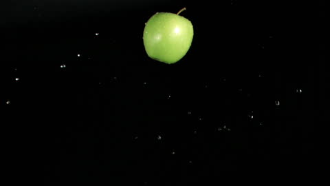 Fresh Green Apple Floating Against Black Background