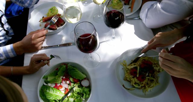 Friends Enjoying Meal with Wine at Outdoor Restaurant - Download Free Stock Images Pikwizard.com