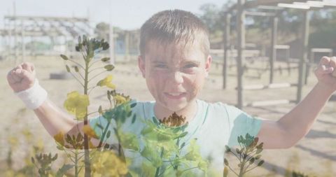 Determined boy flexing muscles on outdoor adventure playground