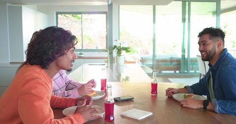 Friends Sharing Casual Lunch Around Modern Kitchen Island, Sunlit Home Gathering