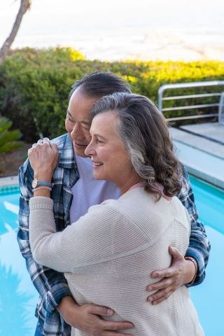 Diverse Couple Sharing an Embrace by the Pool