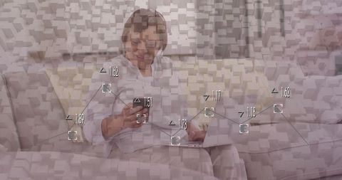 Senior Woman Engaging with Technology on Stylish Sofa