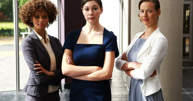 Confident Businesswomen Standing with Arms Crossed in Office Lobby - Download Free Stock Images Pikwizard.com