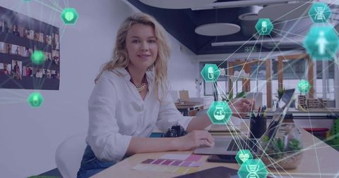 Creative designer typing on laptop and building holographic network with color swatches