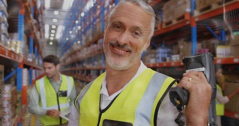 Smiling Warehouse Worker Using Handheld Scanner While Managing Inventory on High Shelving