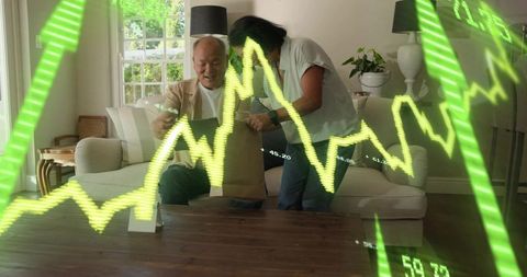Chinese man and senior woman sharing gift while neon stock charts overlay home scene