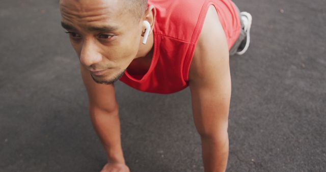 Determined Man Exercising Outdoors in Red Tank Top - Download Free Stock Images Pikwizard.com