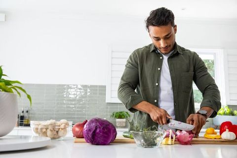 Mature Man Preparing Fresh Ingredients in Modern Kitchen