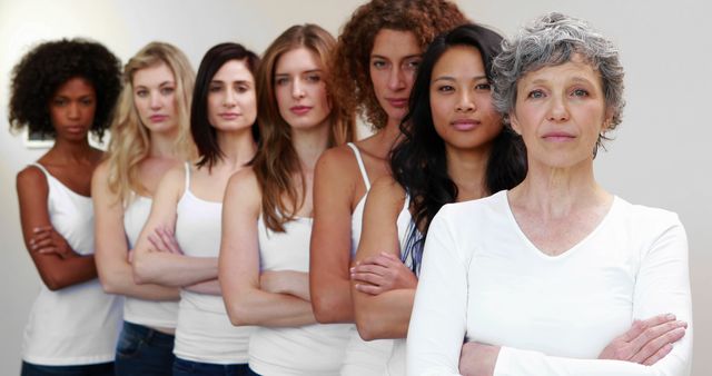Image showing diverse group of women of different ages and ethnicities standing confidently with arms crossed. Ideal for themes related to unity, empowerment, female strength, and inclusivity. Great for campaigns and content promoting diversity and community support.