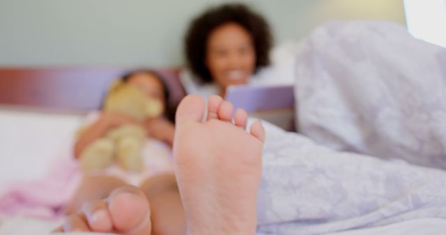 Mother and Daughter Cuddling in Bed with Tablet - Download Free Stock Images Pikwizard.com