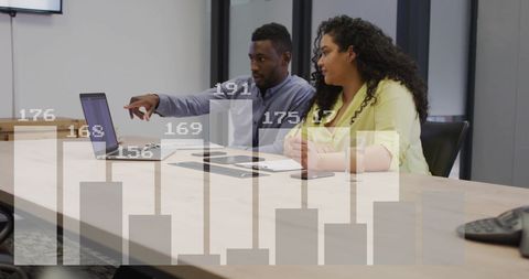 Colleagues Discussing Financial Data Analysis in Office Meeting