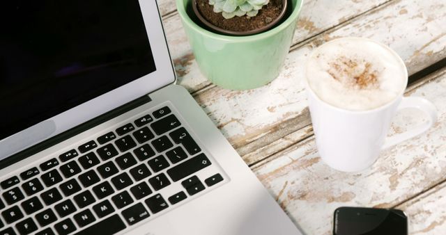 Workspace with Laptop, Coffee, Succulent Plant and Smartphone on Rustic Wooden Table - Download Free Stock Images Pikwizard.com