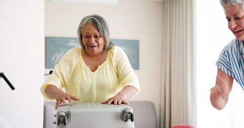 Senior Lesbian Couple Packing for Vacation at Home