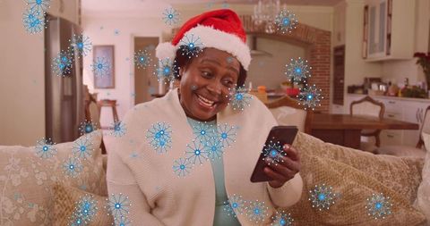 Senior African American Woman Enjoying Christmas with Smartphone Call