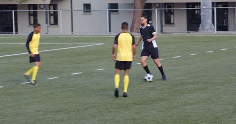 Soccer Players Engaged in Skillful Ball Control During Match