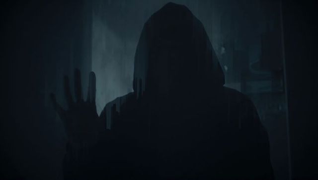 Mysterious Hooded Figure Behind Glass Panel in Dark Basement