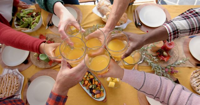 Friends Celebrating with a Toast at a Festive Table - Download Free Stock Images Pikwizard.com