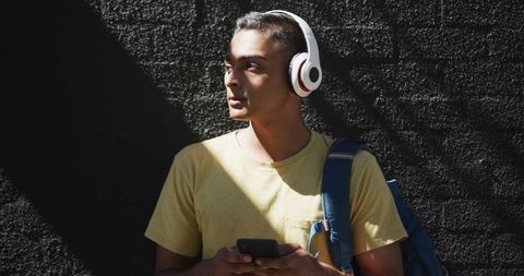 Man Enjoying Music with Headphones Outdoors