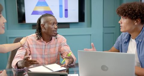 Diverse Team in Dynamic Discussion during Office Meeting