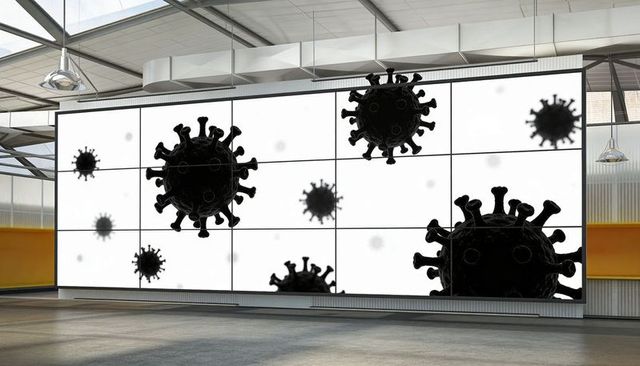 Modern industrial gallery showcasing giant virus silhouettes on multi-panel led wall