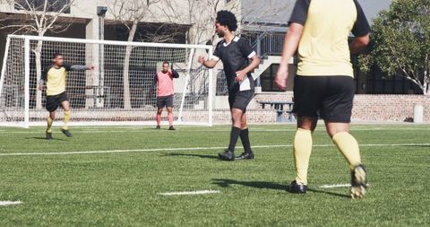 Soccer Players Celebrating Goal on Green Field