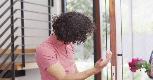 Man with Curly Hair Gesturing in Modern Interior - Download Free Stock Images Pikwizard.com