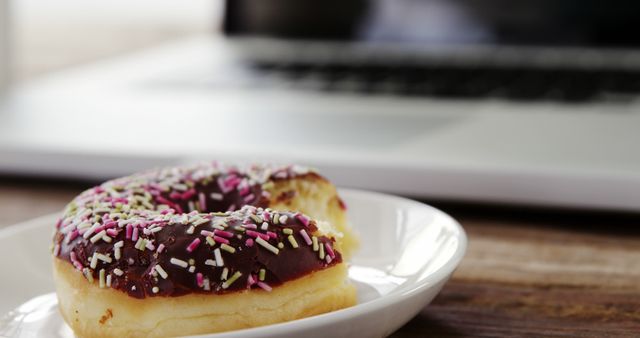 Colorful Sprinkled Donut Near Laptop on Wooden Desk - Download Free Stock Images Pikwizard.com