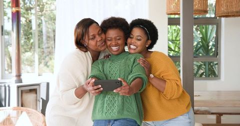 Joyful African American Women Taking Selfie Indoors
