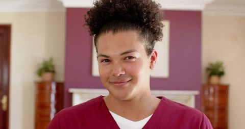 Healthcare professional smiling in warm living room setting