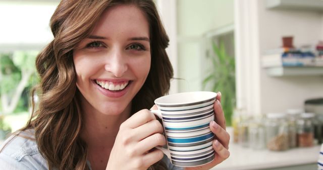 Smiling Woman Drinking Coffee While Relaxing at Home - Download Free Stock Images Pikwizard.com