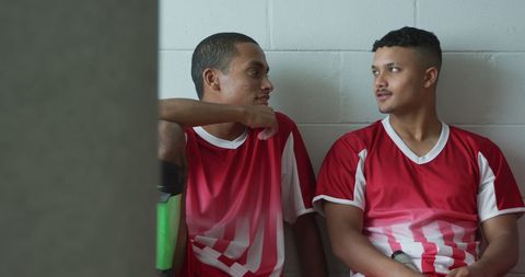 Diverse hockey players relaxing in locker room setting