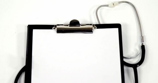 A stethoscope lies next to a clipboard with blank paper, with copy space - Download Free Stock Photos Pikwizard.com