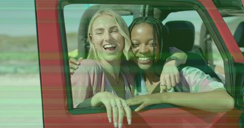 Joyful Friends Hugging Out Car Window on Road Trip Adventure