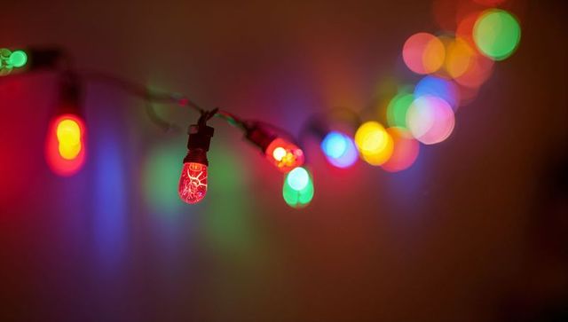 Hanging multicolor string lights showing red filament with warm bokeh glow