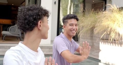 Friends Practicing Outdoor Meditation on Modern Patio