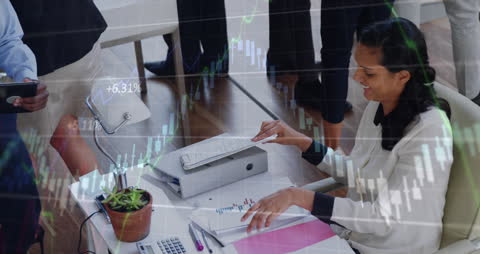 Businesswoman Analyzing Stock Market Trends in Collaborative Office