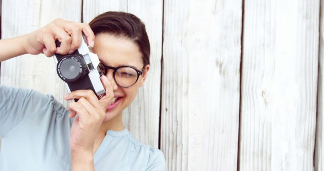 Young Woman Smiling and Taking Photo with Vintage Camera - Download Free Stock Images Pikwizard.com