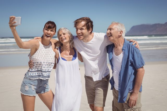 Family enjoying a sunny day at the beach, taking a selfie together. Perfect for promoting family vacations, travel destinations, summer activities, and outdoor fun. Ideal for use in advertisements, travel brochures, and social media campaigns.