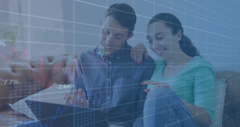 Couple Analyzing Financial Data on Laptop at Home