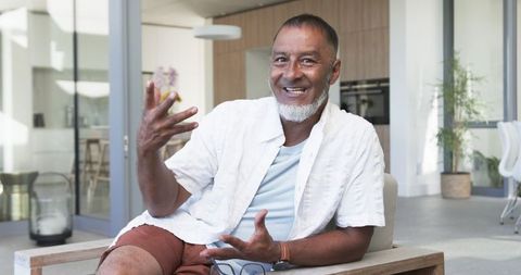 Relaxed older man engaged in conversation at home