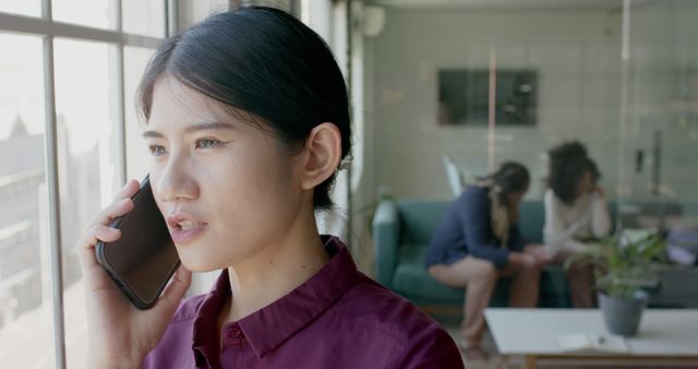 Young Professional Woman Using Phone in Modern Office - Download Free Stock Images Pikwizard.com