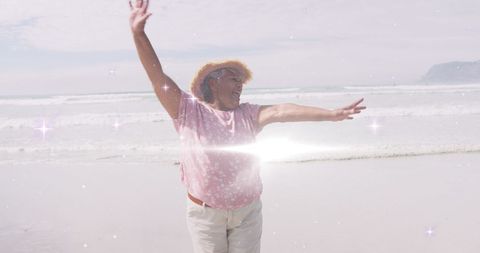 Joyful Senior Woman Dancing on Sunny Beach