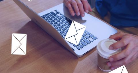 Man Checking Emails on Laptop with Coffee Cup