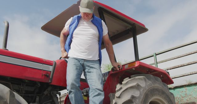 Farmer Stepping Down from Red Tractor - Download Free Stock Images Pikwizard.com